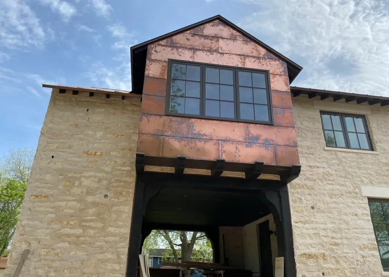 Copper metal panel facade on a stone building for Metal Roof Coating in Silverton